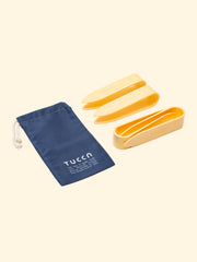Tucca beach towels clips, included in the packaging, that being inserted through the little holes in each corner, will fix your beachtowel to the sand so it doesn't get blown away by the wind. Four clips in a fine and light design. 